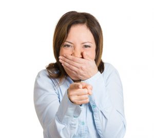 Closeup portrait of young, beautiful, excited, happy woman smiling, laughing, pointing finger towards you, camera gesture, isolated white background. Positive human emotion, attitude, reactions